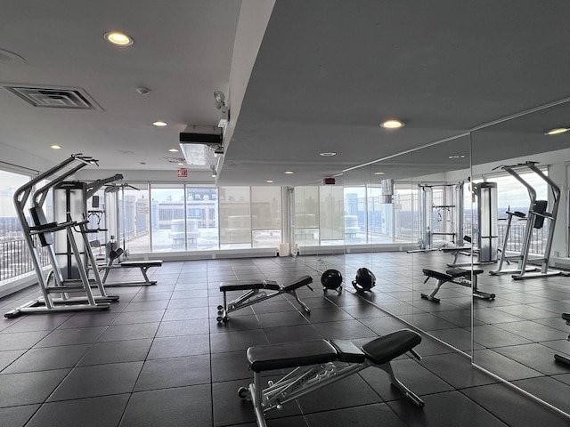 gym with visible vents, a wall of windows, and recessed lighting