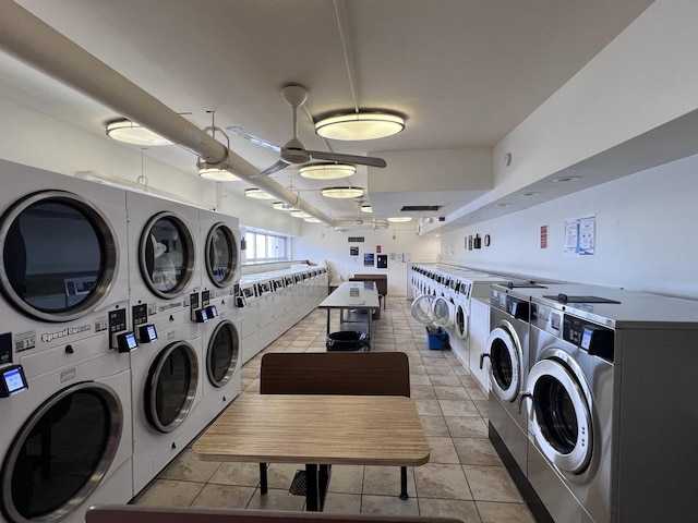 community laundry room with stacked washer / drying machine, independent washer and dryer, and light tile patterned floors