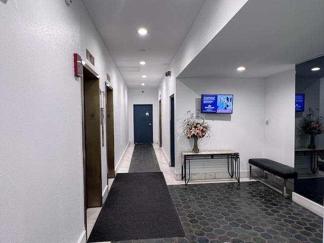 corridor with baseboards and recessed lighting