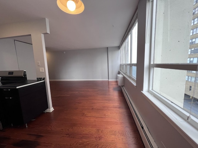 hall with a wall mounted AC, baseboards, and wood finished floors