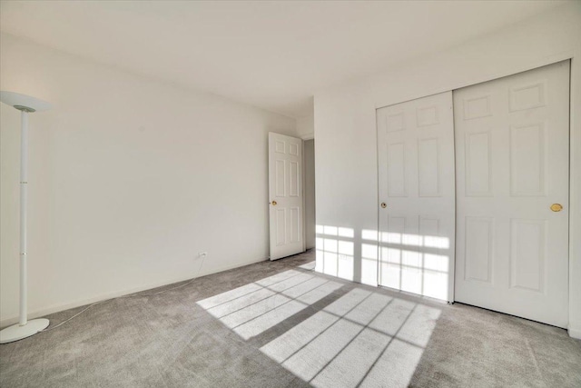 unfurnished bedroom with carpet flooring and a closet