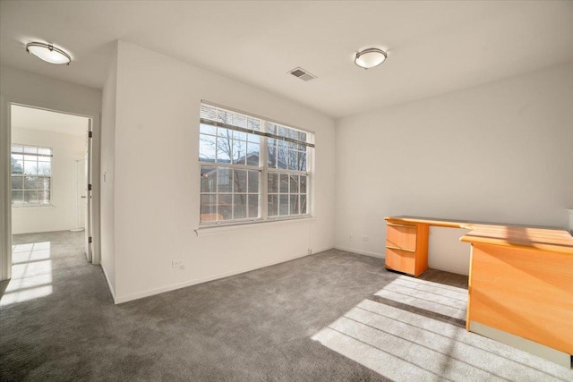 interior space featuring visible vents, carpet floors, and baseboards