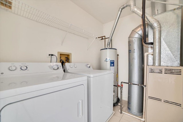 clothes washing area with laundry area, water heater, and washing machine and clothes dryer