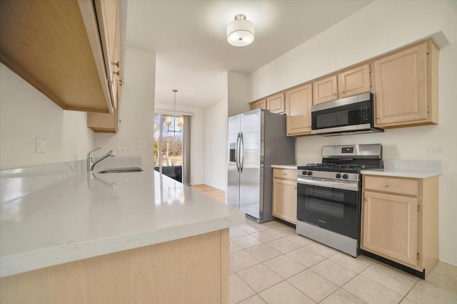 kitchen featuring light brown cabinets, a sink, stainless steel appliances, light tile patterned floors, and a chandelier