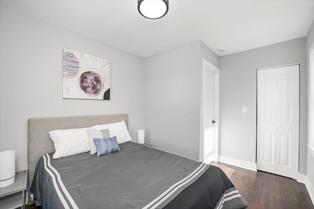 bedroom featuring baseboards and wood finished floors