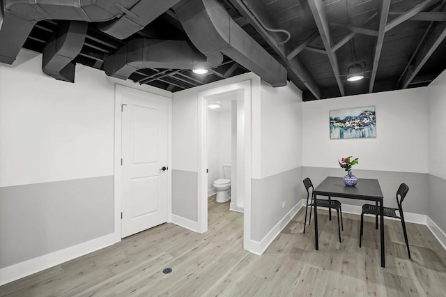 finished basement featuring baseboards and wood finished floors