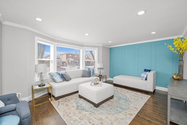 living area with baseboards, dark wood finished floors, crown molding, a decorative wall, and recessed lighting