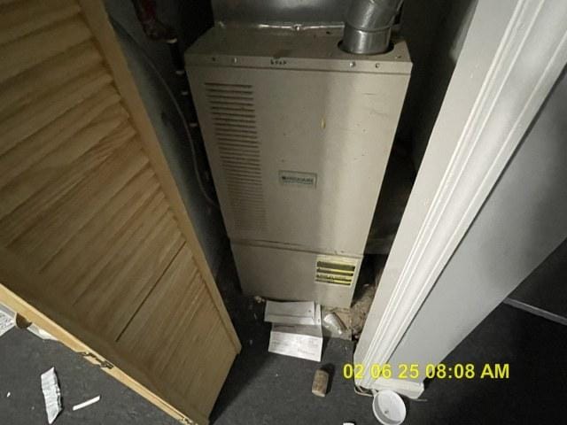 utility room featuring water heater