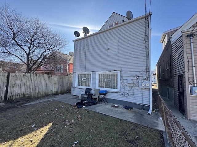 back of house featuring a patio and fence