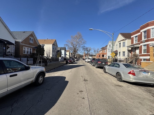 view of street with a residential view and street lights