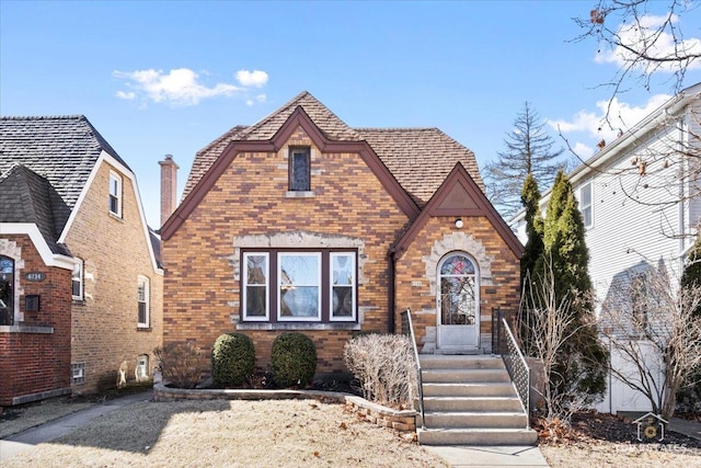 english style home with brick siding