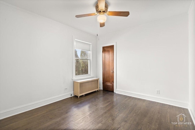 unfurnished room with dark wood finished floors, radiator heating unit, and baseboards
