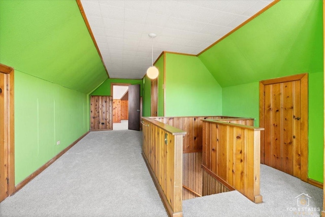 additional living space with lofted ceiling, carpet flooring, and baseboards