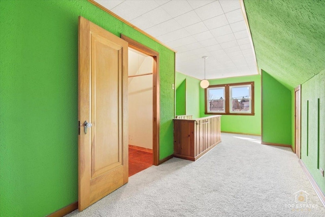 additional living space featuring lofted ceiling and carpet floors