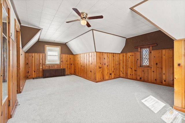 bonus room with carpet floors, radiator, and lofted ceiling