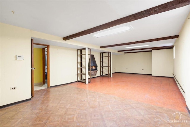 unfurnished room featuring beamed ceiling, light floors, and baseboards