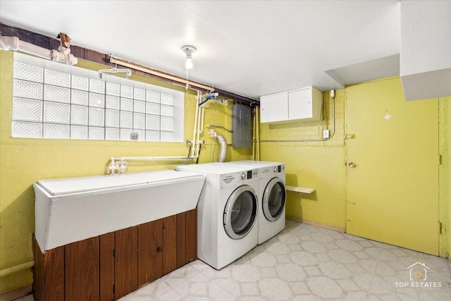 clothes washing area featuring electric panel, light floors, and independent washer and dryer