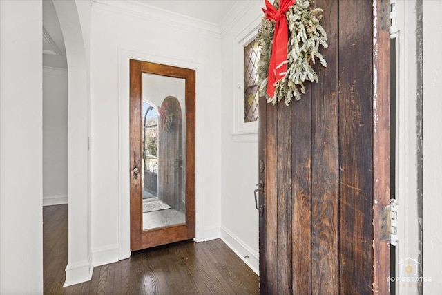 entryway with baseboards, dark wood-style flooring, and ornamental molding