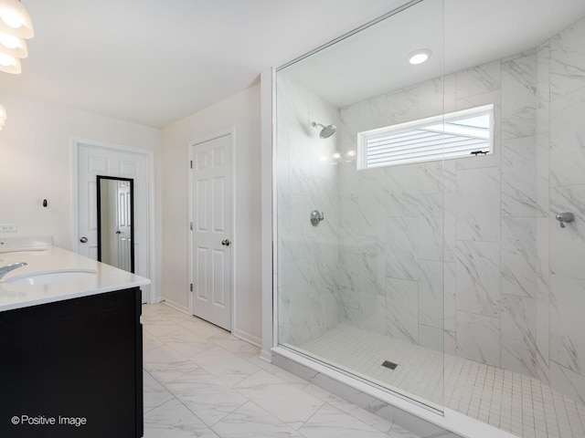 bathroom with baseboards, a marble finish shower, double vanity, a sink, and marble finish floor