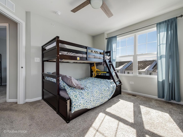 carpeted bedroom featuring visible vents, ceiling fan, and baseboards