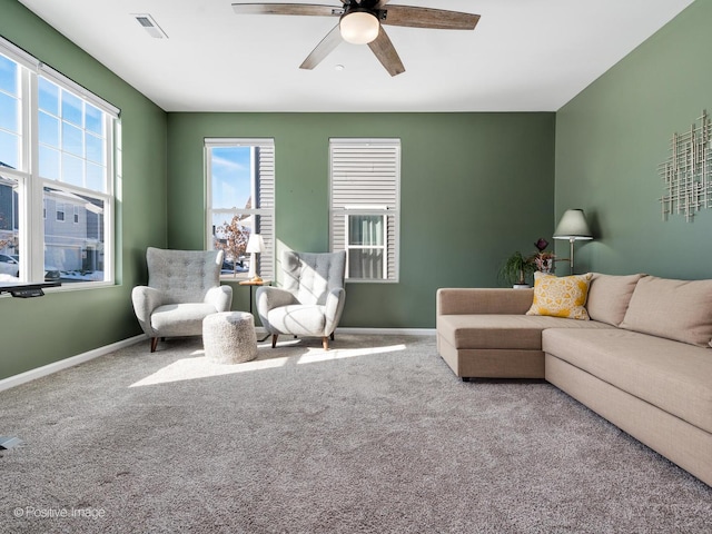 living room with visible vents, a ceiling fan, baseboards, and carpet floors