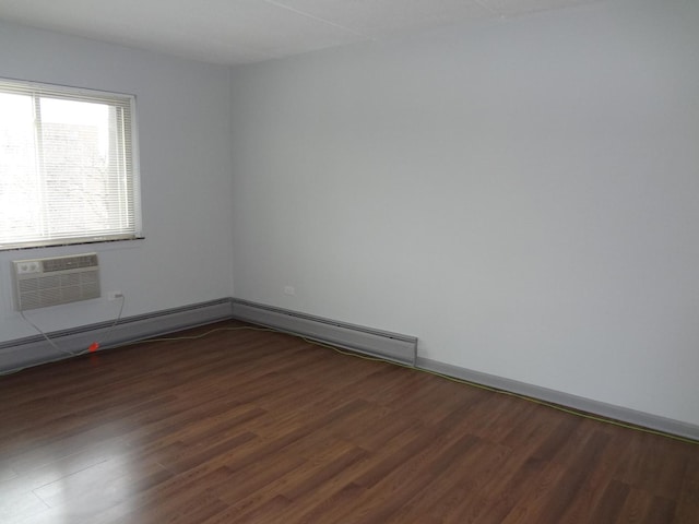 empty room with a wall unit AC and wood finished floors