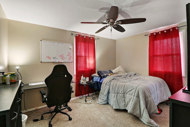 carpeted bedroom with a ceiling fan and baseboards