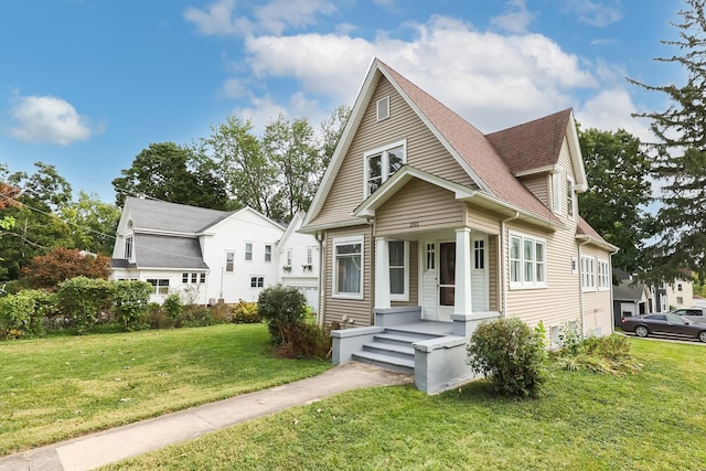 bungalow-style home featuring a shingled roof and a front lawn