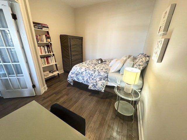 bedroom featuring baseboards and wood finished floors