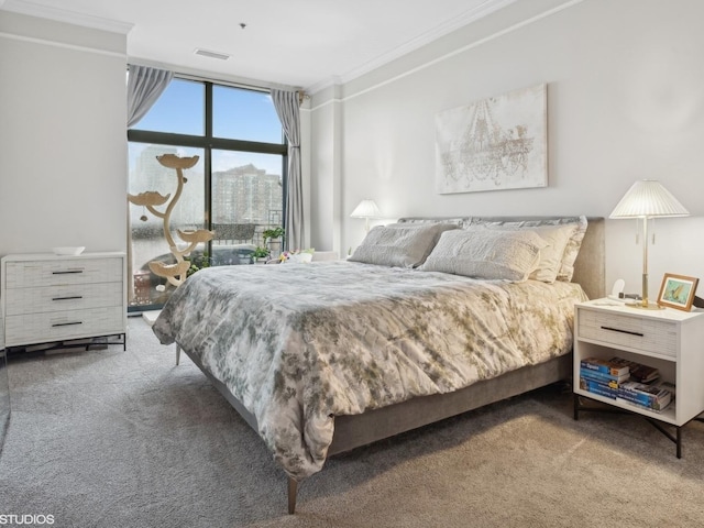 bedroom featuring carpet flooring, visible vents, and ornamental molding