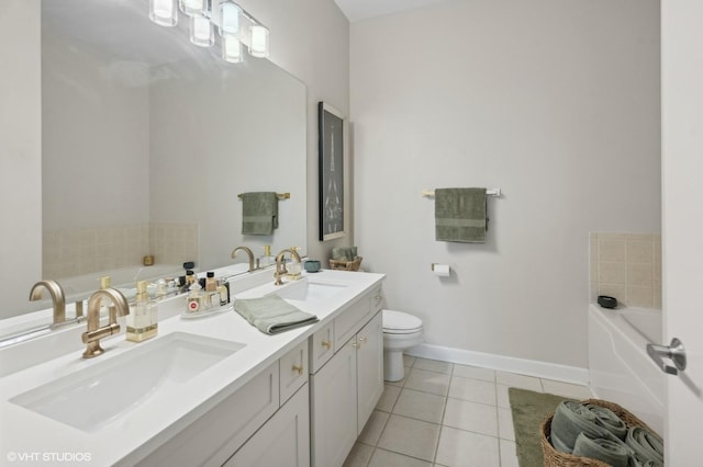 full bathroom with a garden tub, a sink, and tile patterned floors