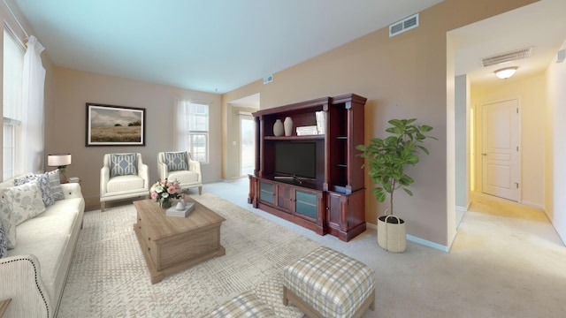 carpeted living room with visible vents and baseboards