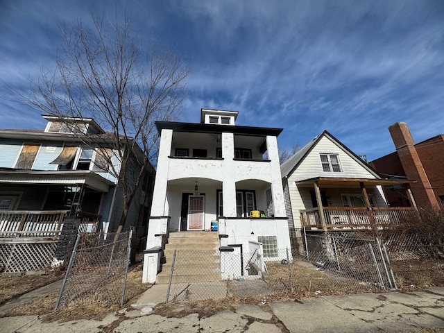 view of front of house with a porch, a gate, a fenced front yard, and stucco siding