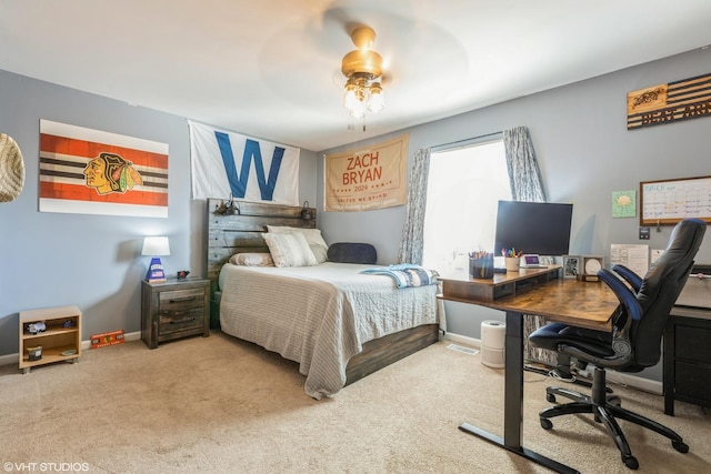 carpeted bedroom featuring baseboards and ceiling fan