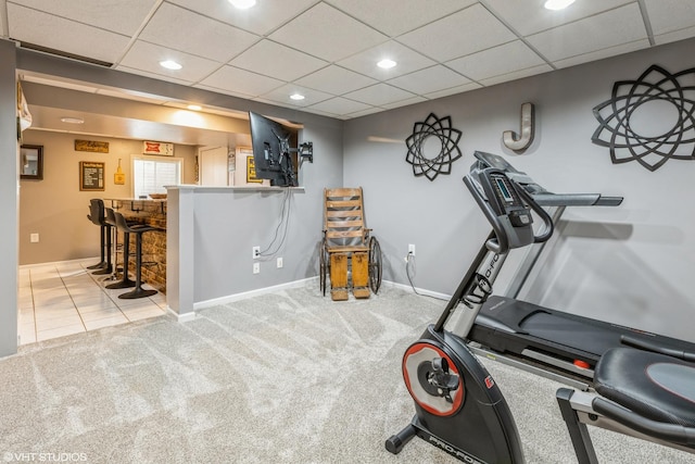 exercise room with baseboards, a drop ceiling, a dry bar, carpet flooring, and recessed lighting