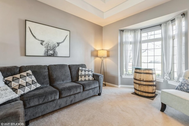 living room with light colored carpet, baseboards, and a healthy amount of sunlight