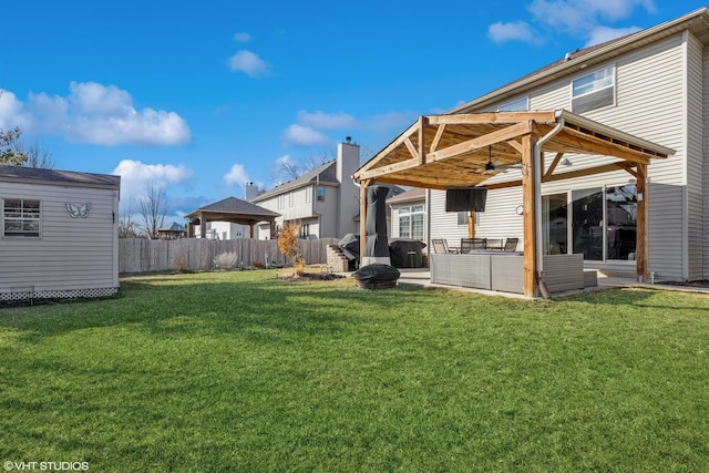 back of house with a patio, a ceiling fan, a yard, a fenced backyard, and an outdoor structure