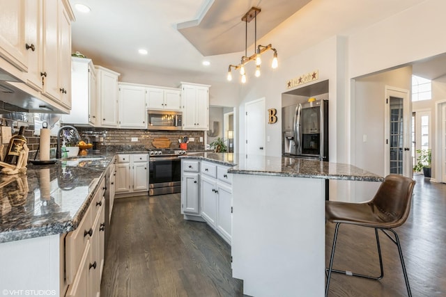 kitchen with a sink, a center island, dark wood-style flooring, and stainless steel appliances