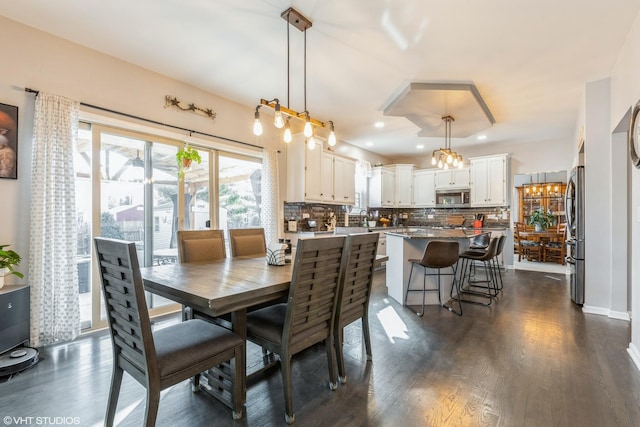 dining room featuring dark wood finished floors and recessed lighting