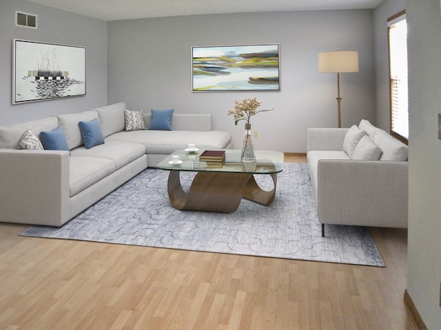 living area with visible vents and wood finished floors