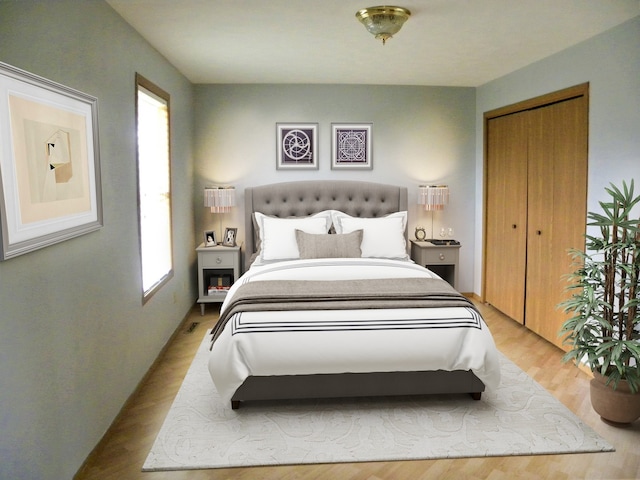 bedroom featuring light wood finished floors, multiple windows, and a closet