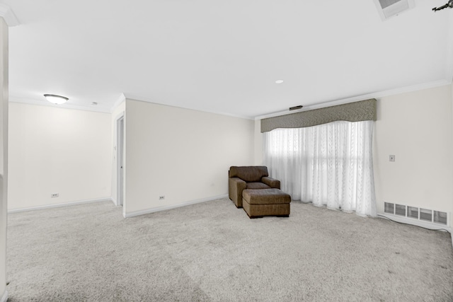 sitting room with visible vents, carpet floors, and crown molding