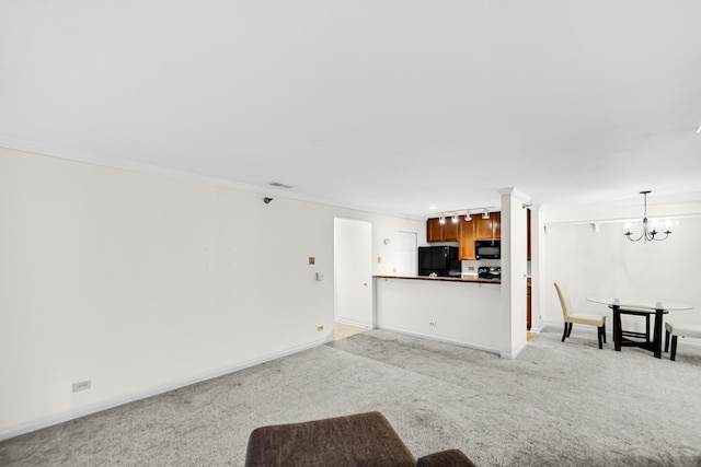 unfurnished living room with baseboards, light carpet, a notable chandelier, and crown molding