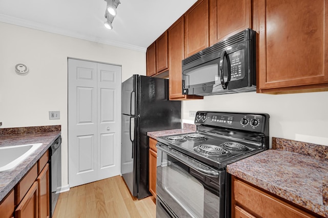 kitchen featuring black appliances, brown cabinetry, light wood-style floors, and ornamental molding