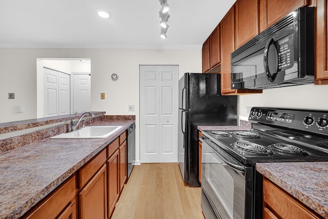 kitchen featuring brown cabinets, black appliances, and crown molding