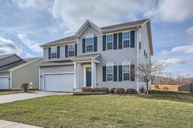 view of front of house featuring a garage, driveway, and a front lawn