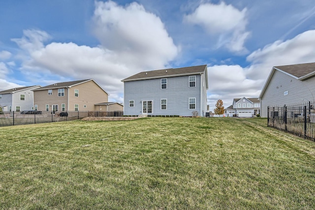 rear view of house featuring a yard, fence, and a residential view