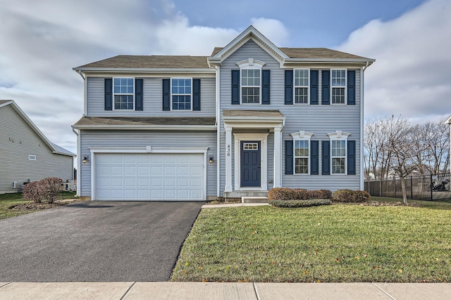 view of front of home featuring aphalt driveway, a front lawn, an attached garage, and fence