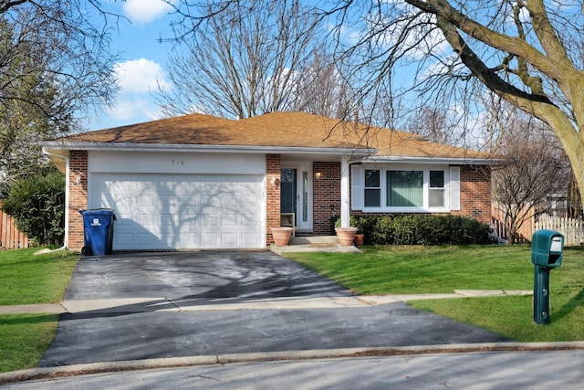 single story home featuring a garage, driveway, brick siding, and a front yard