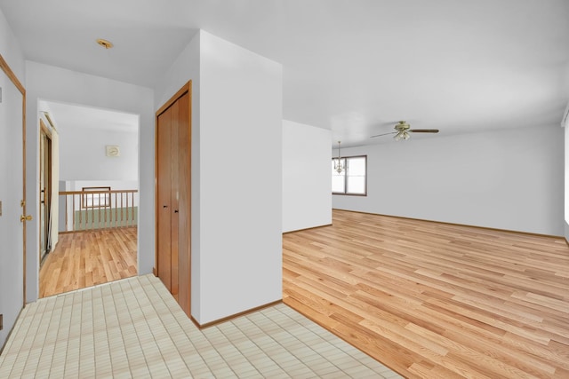 interior space featuring light wood finished floors and an inviting chandelier